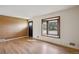 Well-lit living room with hardwood flooring and a striking accent wall, creating a warm ambiance at 6587 S Clarkson St, Centennial, CO 80121
