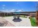 A backyard featuring stone patio with table and chairs under a blue umbrella at 3065 Zion St, Aurora, CO 80011