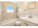 Bright bathroom featuring a tub, shower, window, and vanity with a sink at 3065 Zion St, Aurora, CO 80011