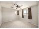 Neutral bedroom with carpet, ceiling fan, and natural light from two windows at 3065 Zion St, Aurora, CO 80011