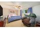 A primary bedroom with bed, chair, and a view from a window at 3065 Zion St, Aurora, CO 80011