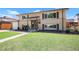 Charming two-story home featuring a brick and siding exterior, manicured lawn, and inviting entryway at 3065 Zion St, Aurora, CO 80011