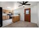 Cozy kitchen featuring wooden cabinets, black appliances, and a breakfast bar at 3065 Zion St, Aurora, CO 80011