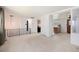 Open living room with neutral carpet, black wrought iron railing and white walls at 3065 Zion St, Aurora, CO 80011