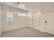 A simple bedroom featuring neutral carpet and white closet doors, with lots of natural light at 1101 S Dahlia St, Denver, CO 80246