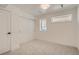 Neutral bedroom featuring a closet with sliding doors, carpet, and ample natural light from the window at 1101 S Dahlia St, Denver, CO 80246
