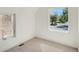 Sunlit bedroom with two windows offering neighborhood views and neutral carpet at 1101 S Dahlia St, Denver, CO 80246