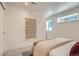 Bright bedroom featuring clean white walls, neutral carpet, and a cozy decorative wall hanging at 1101 S Dahlia St, Denver, CO 80246