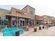 Commercial building with outdoor seating area featuring multiple restaurants, including Illegal Pete's and Cuba Cuba at 1101 S Dahlia St, Denver, CO 80246