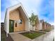 Modern home exteriors feature a unique design with wood and white siding, green doors, and well-maintained landscaping at 1101 S Dahlia St, Denver, CO 80246