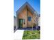 Modern home with unique wood facade, green door and tidy landscaping at 1101 S Dahlia St, Denver, CO 80246