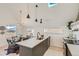 Modern kitchen with island, stainless steel appliances, and an adjacent dining area at 1101 S Dahlia St, Denver, CO 80246