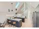 Bright kitchen boasts skylight, sleek cabinetry, island with seating, and stainless steel refrigerator at 1101 S Dahlia St, Denver, CO 80246