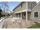 Wide wooden deck with outdoor seating, overlooking the landscaped backyard at 3821 S Magnolia Way, Denver, CO 80237
