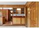 A retro bar area with wood cabinets, and a small sink, perfect for entertaining guests at 3821 S Magnolia Way, Denver, CO 80237