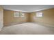 Spacious carpeted bedroom featuring three large windows, neutral walls, and ample natural light at 3821 S Magnolia Way, Denver, CO 80237