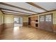 Open dining space with hardwood flooring, wood beams, and vintage decor at 3821 S Magnolia Way, Denver, CO 80237