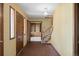 Traditional foyer with brick flooring, wooden staircase, and paneled doors at 3821 S Magnolia Way, Denver, CO 80237