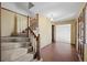 Entryway features a staircase, brick flooring, and patterned wallpaper at 3821 S Magnolia Way, Denver, CO 80237