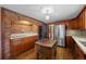 This kitchen features a brick archway, stainless steel appliances, wood cabinets and a butcher block island at 3821 S Magnolia Way, Denver, CO 80237