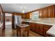 Spacious kitchen boasts wood cabinets, stainless steel appliances, and a butcher block island, perfect for cooking at 3821 S Magnolia Way, Denver, CO 80237