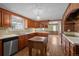 Bright kitchen featuring wood cabinets, stainless steel appliances, and butcher block island and white countertops at 3821 S Magnolia Way, Denver, CO 80237