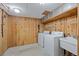 Laundry room with washer, dryer, utility sink, wood walls and drop ceiling at 3821 S Magnolia Way, Denver, CO 80237