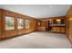 This living room boasts wood paneling, large windows, and built-in cabinets, offering a blend of classic charm at 3821 S Magnolia Way, Denver, CO 80237
