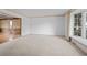 Bright and airy living room with neutral carpet, large windows, and classic trim at 3821 S Magnolia Way, Denver, CO 80237