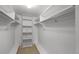 Walk-in closet with carpet, white walls, shelving and hanging rods, maximizing storage at 3821 S Magnolia Way, Denver, CO 80237