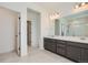Bathroom featuring double vanity and large mirror at 18049 E 106Th Ave, Commerce City, CO 80022