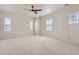 Spacious bedroom with carpet, ceiling fan and multiple windows at 18049 E 106Th Ave, Commerce City, CO 80022
