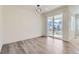 Bright dining room featuring modern light fixture, sliding glass door, and stylish gray flooring at 18049 E 106Th Ave, Commerce City, CO 80022