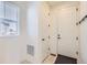 Bright entryway featuring a tiled floor, coat hooks, and multiple storage spaces at 18049 E 106Th Ave, Commerce City, CO 80022