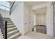 Bright entryway featuring a staircase with dark railing and a view into the adjacent rooms at 18049 E 106Th Ave, Commerce City, CO 80022
