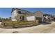 Side view of home showing the yard with a wooden fence and a driveway at 18049 E 106Th Ave, Commerce City, CO 80022