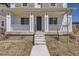 Inviting front porch with white railing and columns, leading to a gray front door with house number at 18049 E 106Th Ave, Commerce City, CO 80022