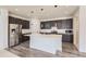 Spacious kitchen with a large island, stainless steel appliances, and dark cabinetry at 18049 E 106Th Ave, Commerce City, CO 80022