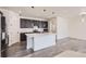 Modern kitchen features a central island, stainless steel appliances, and sleek dark cabinetry at 18049 E 106Th Ave, Commerce City, CO 80022