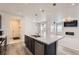 Well-lit kitchen with a central island, stainless steel appliances, and an open view to the living area at 18049 E 106Th Ave, Commerce City, CO 80022