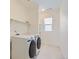 Laundry room with a new washer and dryer and white shelving at 18049 E 106Th Ave, Commerce City, CO 80022