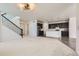 Open-concept living space with stairs, dark cabinets, stainless steel appliances, and hardwood floors at 18049 E 106Th Ave, Commerce City, CO 80022