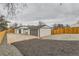 Backyard view showcasing landscaping, modern detached garage, fresh exterior paint, and privacy fence at 1120 Xenia St, Denver, CO 80220
