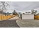 Fresh backyard landscaping with stone and mulch, a privacy fence and a quaint exterior door at 1120 Xenia St, Denver, CO 80220
