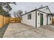 Exterior view of the backyard and side of the house with a green door and wood fence at 1120 Xenia St, Denver, CO 80220