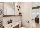 Cozy bathroom offers floating shelves, modern lighting, and hardwood flooring at 1120 Xenia St, Denver, CO 80220