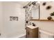 Stylish bathroom boasts decorative tile, modern vanity, and shower and bath at 1120 Xenia St, Denver, CO 80220