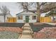 Charming home featuring a well-maintained yard, brick accents, and a welcoming green front door at 1120 Xenia St, Denver, CO 80220