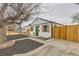Quaint home with modern landscaping and a new fence, featuring a green door and modern touches at 1120 Xenia St, Denver, CO 80220