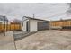 View of updated garage, siding, landscaping, fencing and concrete driveway at 1120 Xenia St, Denver, CO 80220